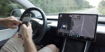 Elon Musk says his Teslas are so good at autonomous driving that we will be able to use our cell phones—the police deny this