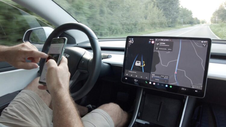 Elon Musk says his Teslas are so good at autonomous driving that we will be able to use our cell phones—the police deny this